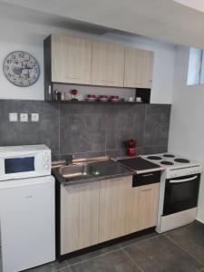 a kitchen with a sink and a stove at Вила Полина in Varna City