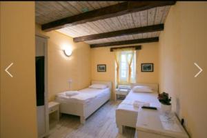 a room with two beds and a table in it at Hotel S Family Jovicevic in Rijeka Crnojevića