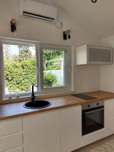a kitchen with a sink and a window at Apartman LUCIJA in Korčula