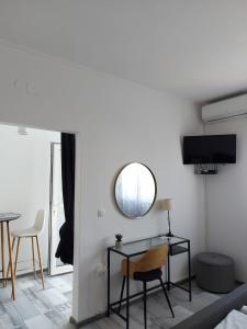 a living room with a table and a mirror at Apartman LUCIJA in Korčula