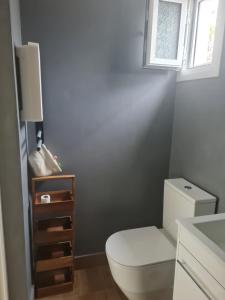a bathroom with a white toilet and a window at Riviera Studio in Athens
