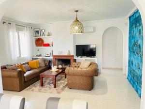 a living room with two couches and a tv at Casa Azure in Gran Alacant