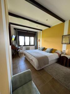 a bedroom with a large bed and a desk at A Lastriña in Trives