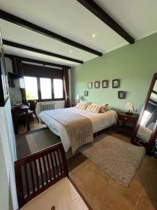 a bedroom with a large bed in a room at A Lastriña in Trives