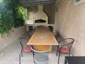 a table and chairs in front of a fireplace at My Villa in Yerevan