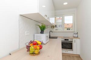 a kitchen with a bowl of fruit on the floor at Lanuna apartment in Split