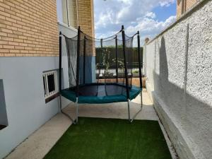 a swing on a balcony with green grass at CasaCascante in Cascante