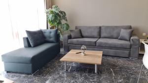 a living room with a couch and a coffee table at Ladadika 5th Floor in Thessaloniki