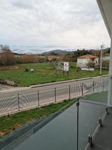 a view of a road and a field from a balcony at Villas Camargo.suites in Camargo