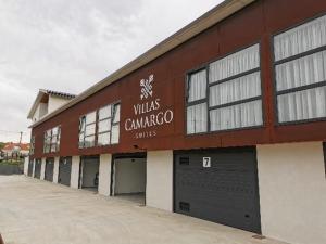 a brown building with a sign on the side of it at Villas Camargo.suites in Camargo