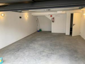an empty garage with white walls and concrete floors at Villas Camargo.suites in Camargo