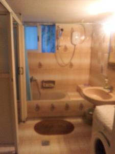 a bathroom with a tub and a toilet and a sink at Vacations in Patra Rooms in Patra