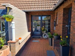 eine Haustür eines Hauses mit Pflanzen und Blumen in der Unterkunft Haus Schilling in Esens