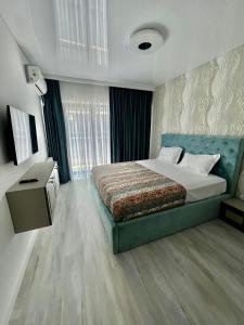 a bedroom with a large bed and a window at Penthouse Blue Boutique Magic View in Mamaia