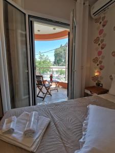 a bedroom with a bed and a view of a patio at KEY POINT Town House in Corfu Town
