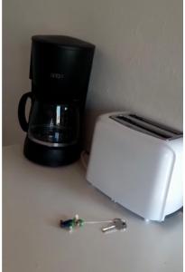 a coffee maker and a toaster on a counter at Quarto Santo António in Zambujeira do Mar