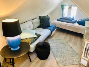 a living room with a couch and a bed at Downtown Historical House with Renovated apartments in Ålesund