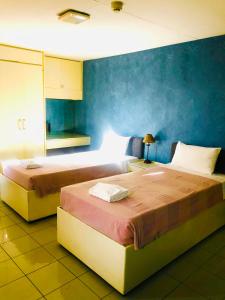 Postel nebo postele na pokoji v ubytování Benson Hotel San Juan CIty