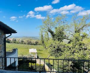 a view of a field from a balcony of a house at Il Poggio da Katia in Saturnia