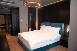 A bed or beds in a room at Toka Hotel Restaurant