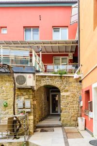 a brick building with a balcony on top of it at JMJ Green view in Piran