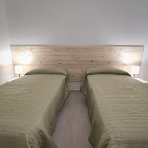 two twin beds in a bedroom with two lamps at In Centro - Noto in Noto