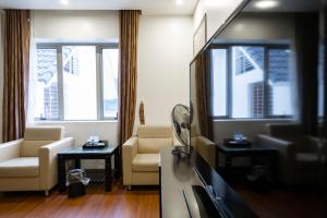 a living room with a couch and a tv at LUXURY HOTEL in Ha Long +14 photos