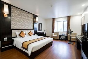 a hotel room with a bed and a television at LUXURY HOTEL in Ha Long