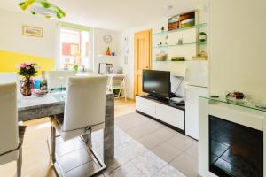 a kitchen with a desk and a tv in a room at JMJ Green view in Piran