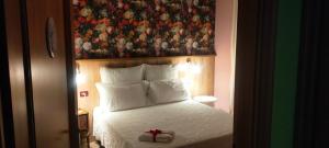 1 dormitorio con 1 cama con una foto en la pared en B&B L'Albero Di Antonia en Atri