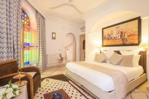 a bedroom with a bed and a stained glass window at Riad Alma in Marrakech