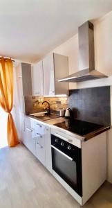 a kitchen with a sink and a stove at La suite de Mathilde Disneyland Paris in Montévrain