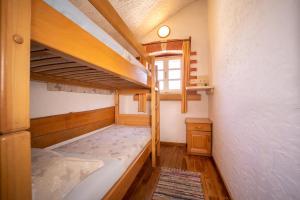 a bedroom with two bunk beds and a window at The Ultimate Escape - traditional cottage & private pool in Selca +30 photos