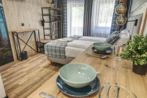 a room with a bed and a table with bowls on it at Skansen Forest in Liszki