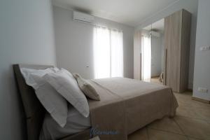 A bed or beds in a room at San Martino Holiday Apartments