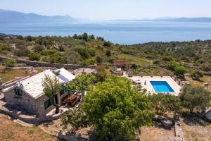 an aerial view of a villa with a swimming pool at The Ultimate Escape - traditional cottage & private pool in Selca
