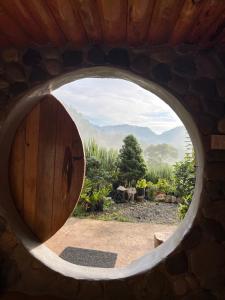 a round window in a building with a view of a garden at The Shire of Sagada in Sagada