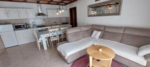 a living room with a couch and a table at apartman Sanja in Rab