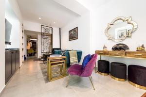 a living room with a table and chairs and a mirror at Casa Toro Calpe in Calpe