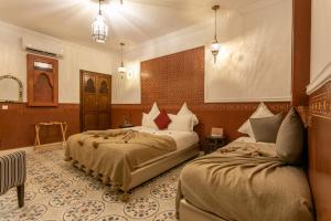 una habitación de hotel con 2 camas en una habitación en Riad Dar Yema, en Marrakech