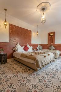 a hotel room with two beds in a bedroom at Riad Dar Yema in Marrakesh