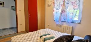 Postel nebo postele na pokoji v ubytování Apartments Pinezić