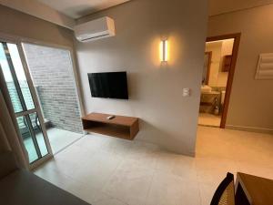 a living room with a flat screen tv on a wall at Salinas Exclusive Resort in Salinópolis