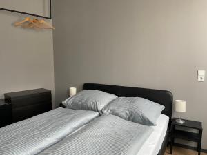 a bed with two pillows on it in a bedroom at Alpha Fremdenzimmer in Fürth