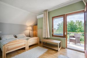 a bedroom with a bed and a large window at Katica Apartment in Balatonszárszó