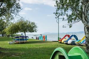 a park with a bunch of playground equipment and the water at Katica Apartment in Balatonszárszó