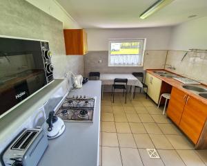 a small kitchen with a stove and a sink at Camping nr 61 in Elblag