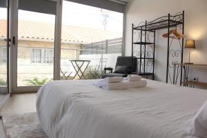 a bedroom with a large white bed and a large window at Casa Dona Ana in Carviçais