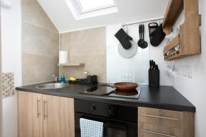 a small kitchen with a sink and a counter top at Sallins Loft in Sallins