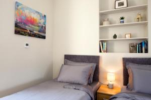 a bedroom with two beds and a book shelf at Sallins Loft in Sallins